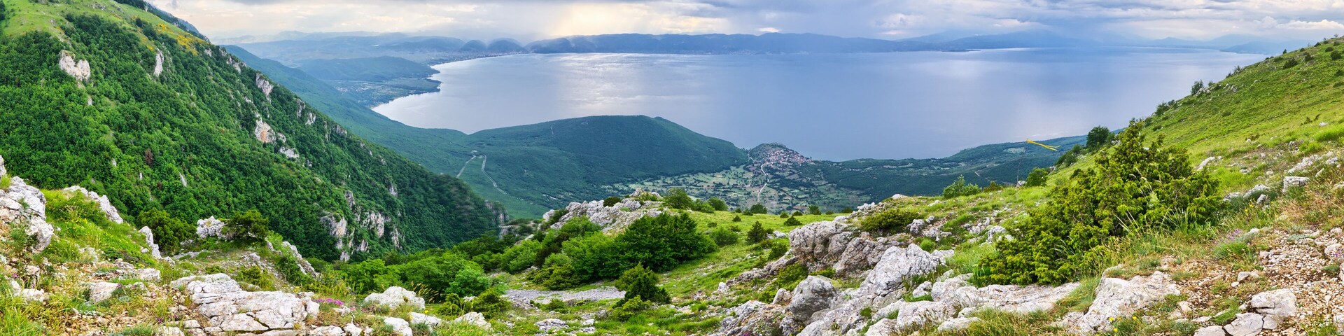 A mountainous landscape with a lake and a small settlement.
