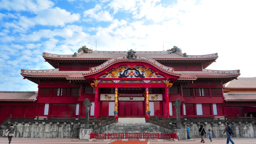 A traditional red building with ornate decorations and a large entrance.