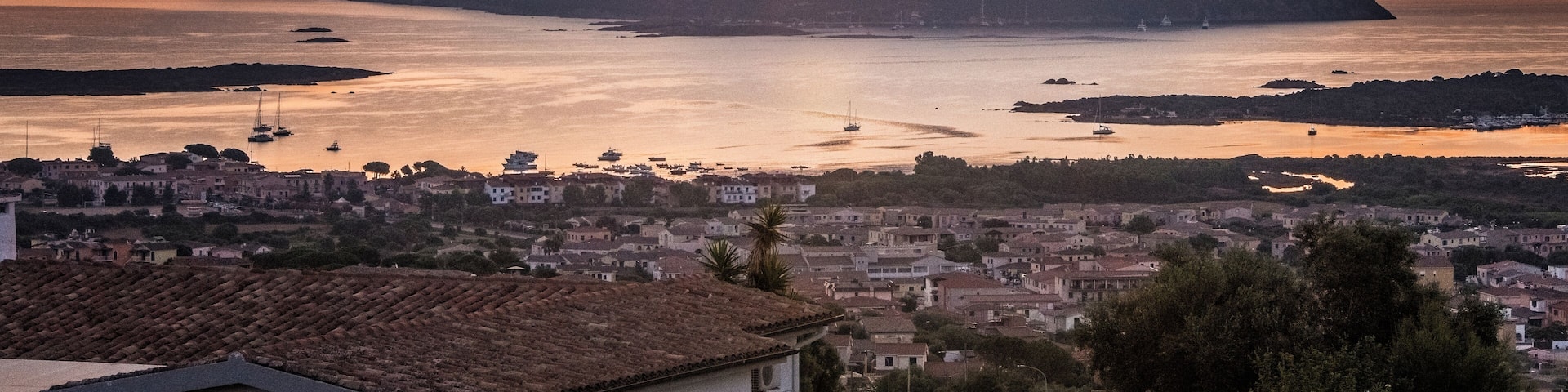 Tavolara Island sunrise as seen from Porto San Paolo, Sardinia. This majestic 1800-foot limestone cliff can be seen from many Sardinian beaches. It is a stunning background when enjoying a day at the beach. #Gold
