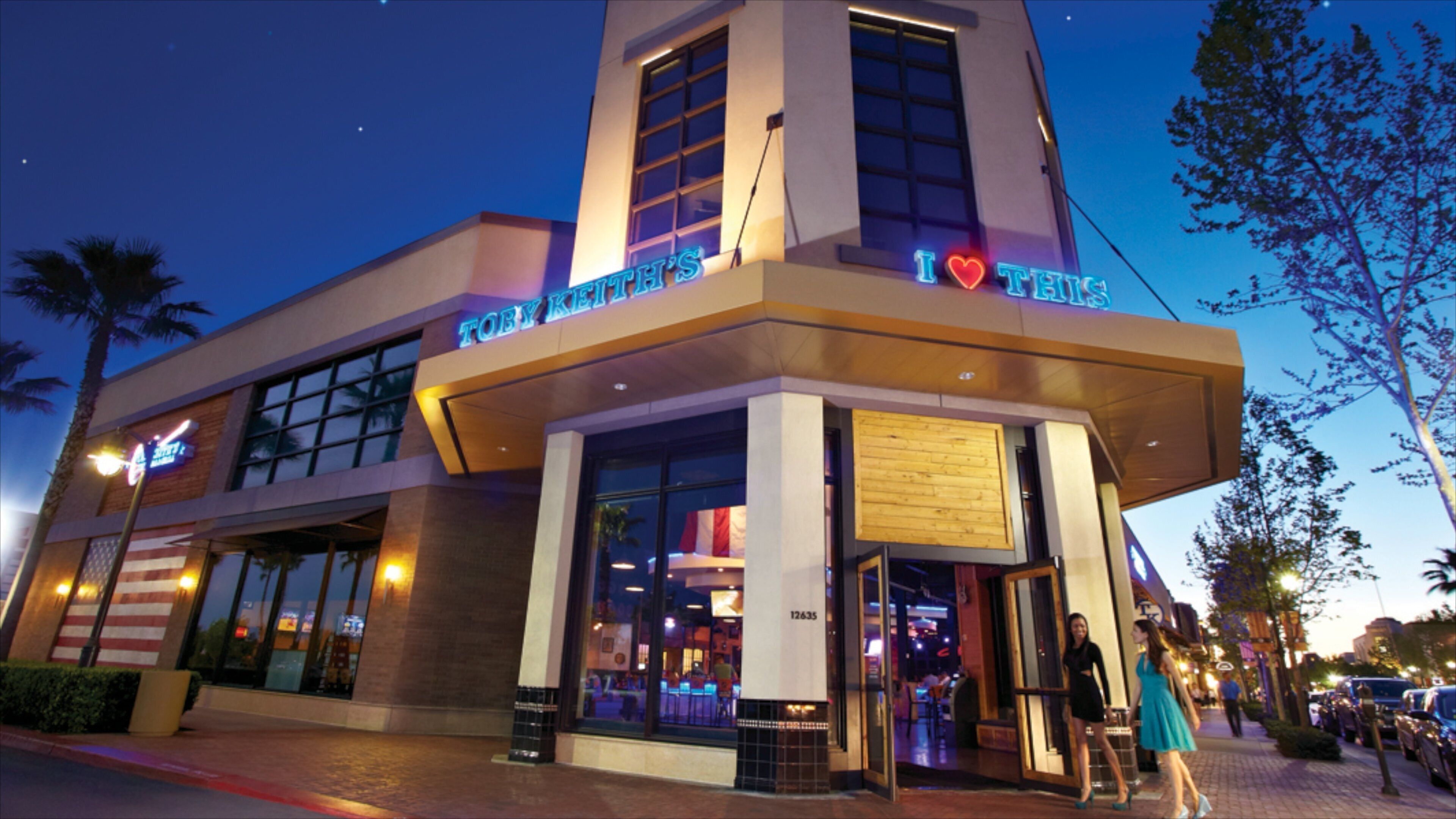 A building with a neon sign that reads "I ♥ THIS" and a sign above the entrance that says "TOBY KIRK'S".