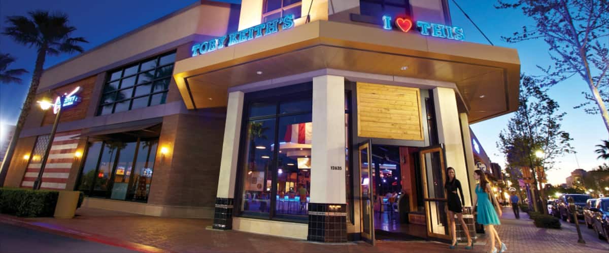 A building with a neon sign that reads "I ♥ THIS" and a sign above the entrance that says "TOBY KIRK'S".