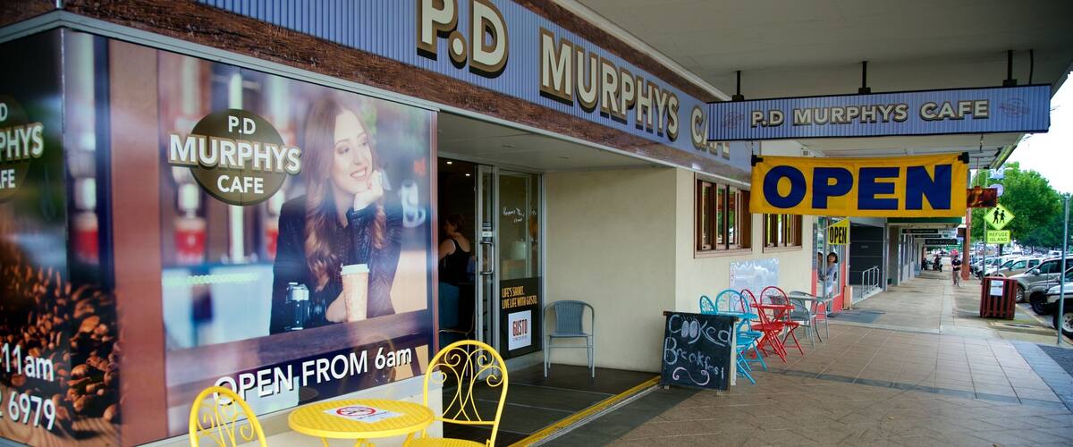 A P.D. Murphy's Cafe with outdoor seating and a 'OPEN' sign.