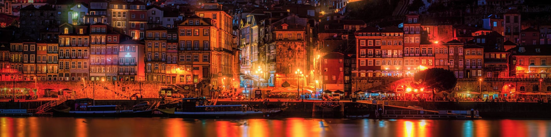 Beautiful warm sunset from Porto in Portugal overlooking the old town harbour with the view over the Douro river.
