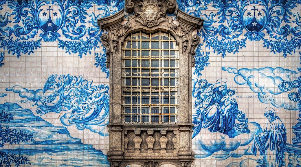 "Azulejo" is a form of Spanish and Portuguese painted tin-glazed ceramic tilework. Azulejos are found on churches, palaces, ordinary houses, schools, and nowadays, restaurants, bars and even railways or subway stations. They were not only used as an ornamental art form but also had a specific functional capacity like temperature control in homes. I photographed this beautiful artwork outside of the "Igreja do Carmo" church in Porto, Portugal.