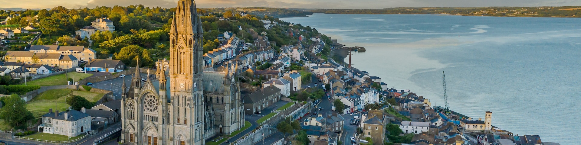 A coastal town with a prominent church spire, a waterfront, and a mix of residential and commercial buildings.