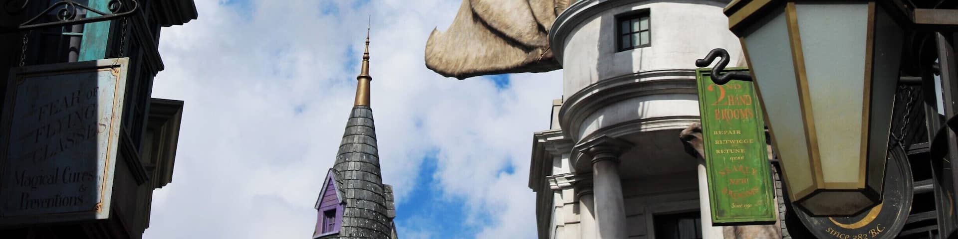 A dragon statue in a city square with buildings around it.