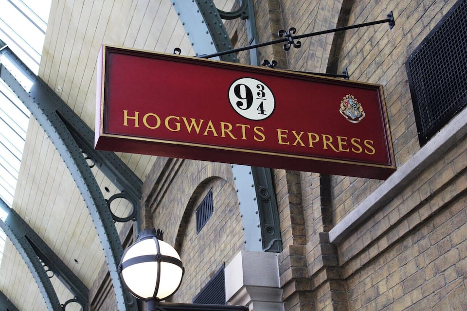 A sign for "Hogwarts Express" with a number "934" and a crest.