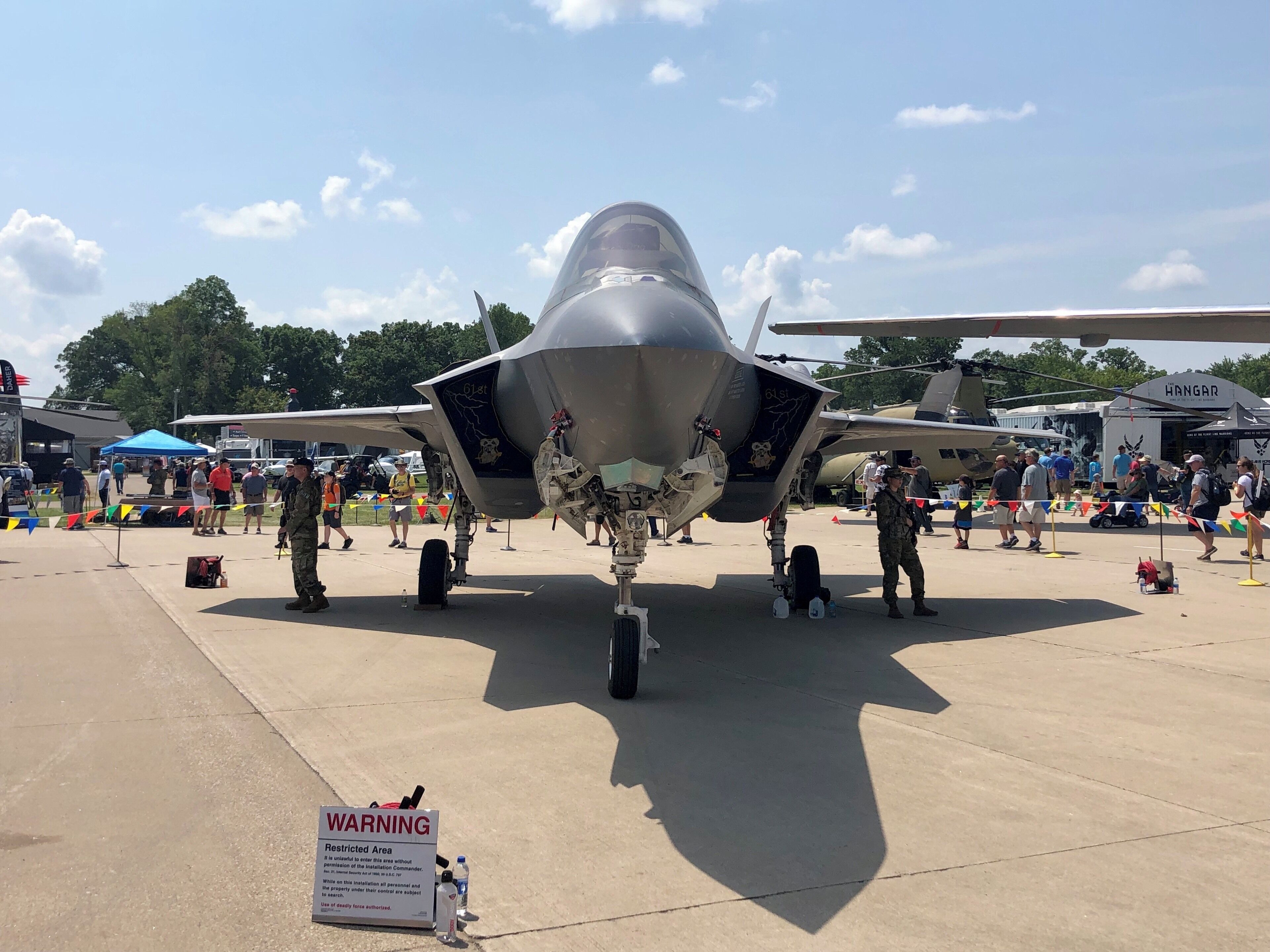 The Air Force F35 compete with two armed service people.
