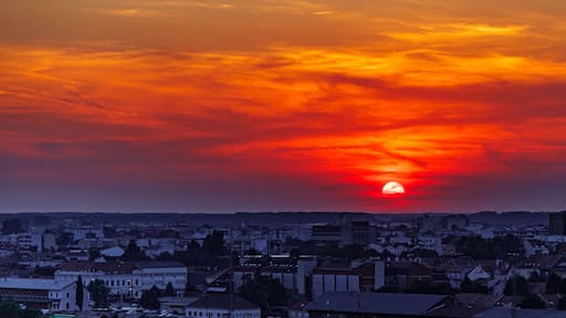 Sunset over Osijek, Croatia with cityscape view and prominent church tower silhouette