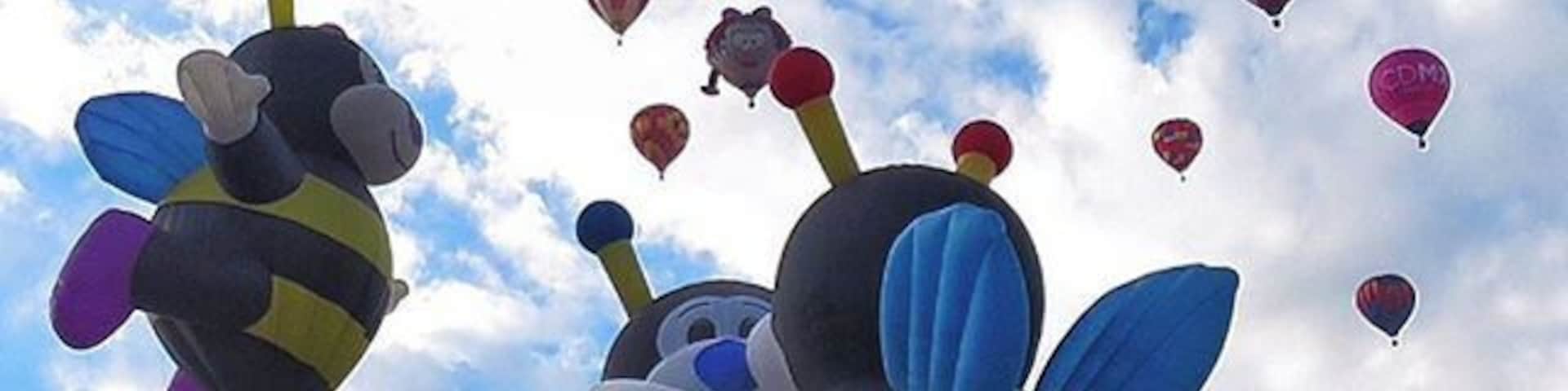 Kissing bumblebees while junior looks on during mass ascension at the Balloon Fiesta in Albuquerque, NM
