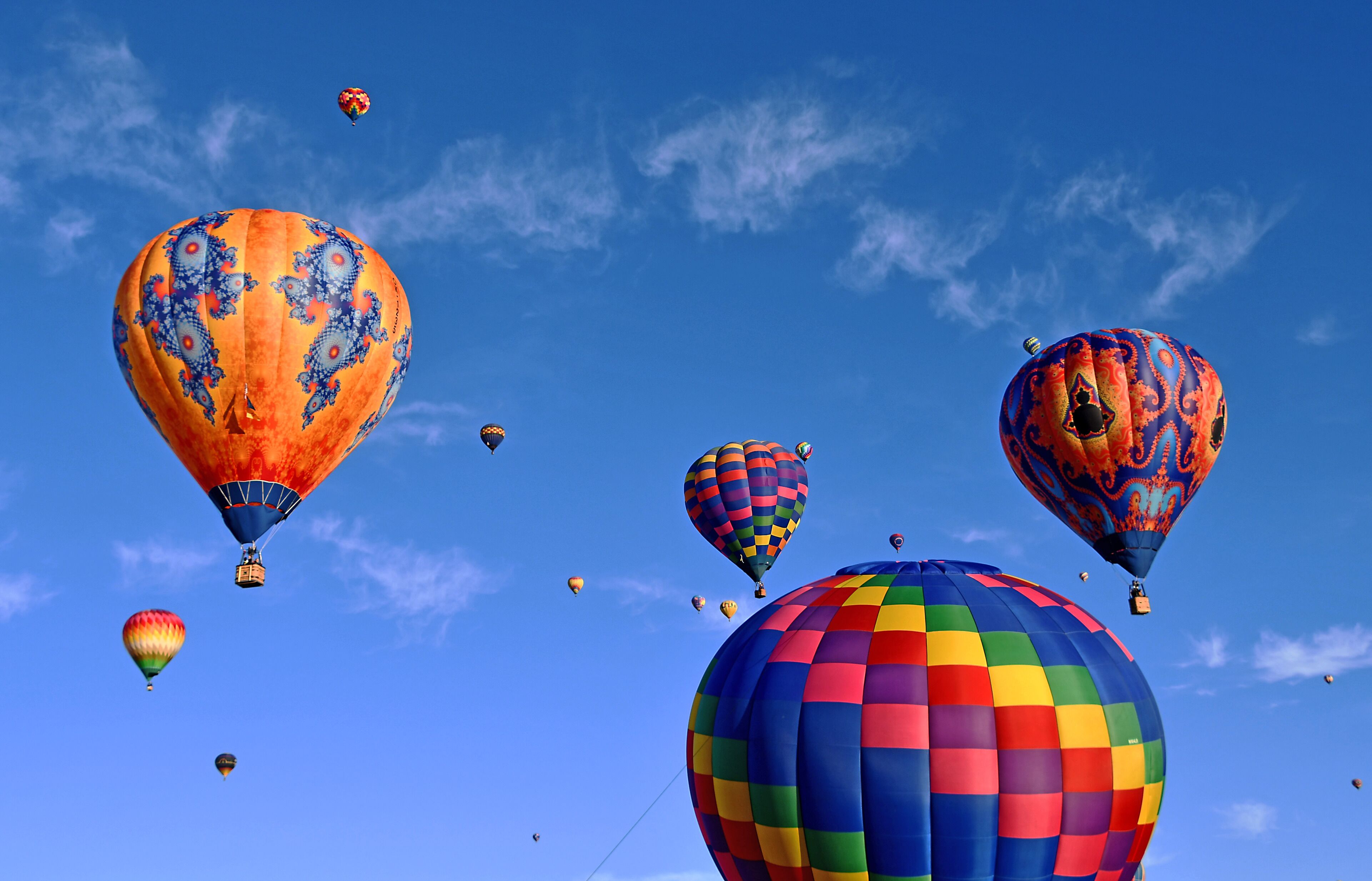 Mass Accession. The last Saturday of the 2019 Fiesta there were around 600 hot air balloons scheduled to go up. Organized chaos is the best way to describe it.  Color, sounds, people everywhere.  It was great!