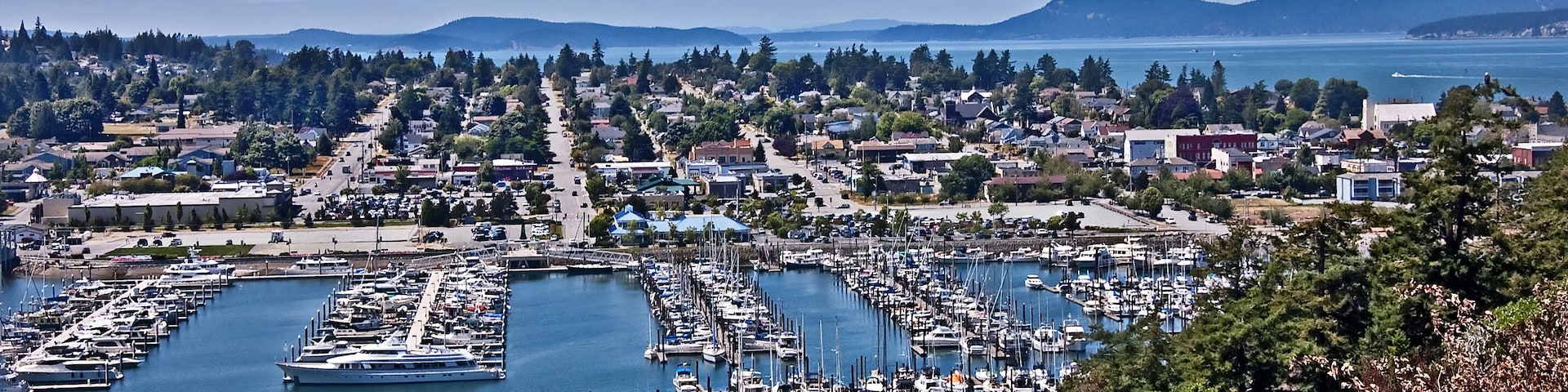 This is an aerial landscape of Anacortes Washington, overlooking the marina. Puget Sound and the San Juan Islands are in the distance. Small coastal town in Skagit County, Washington state.; Shutte