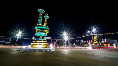 A brightly lit tower with multiple levels and a sign reading "CONVICTION" at its base.