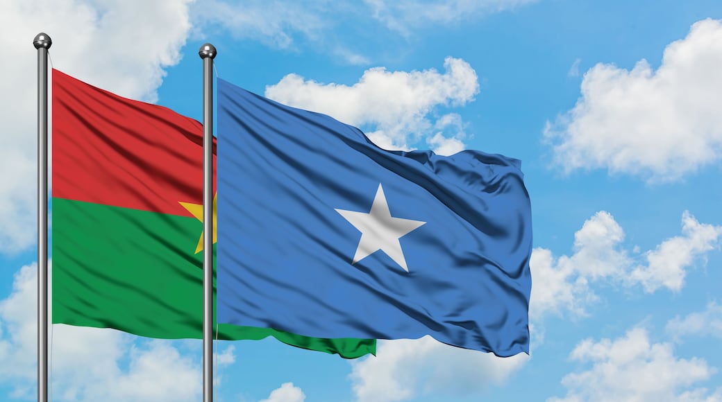 Burkina Faso and Somalia flag waving in the wind against white cloudy blue sky together. Diplomacy concept, international relations.