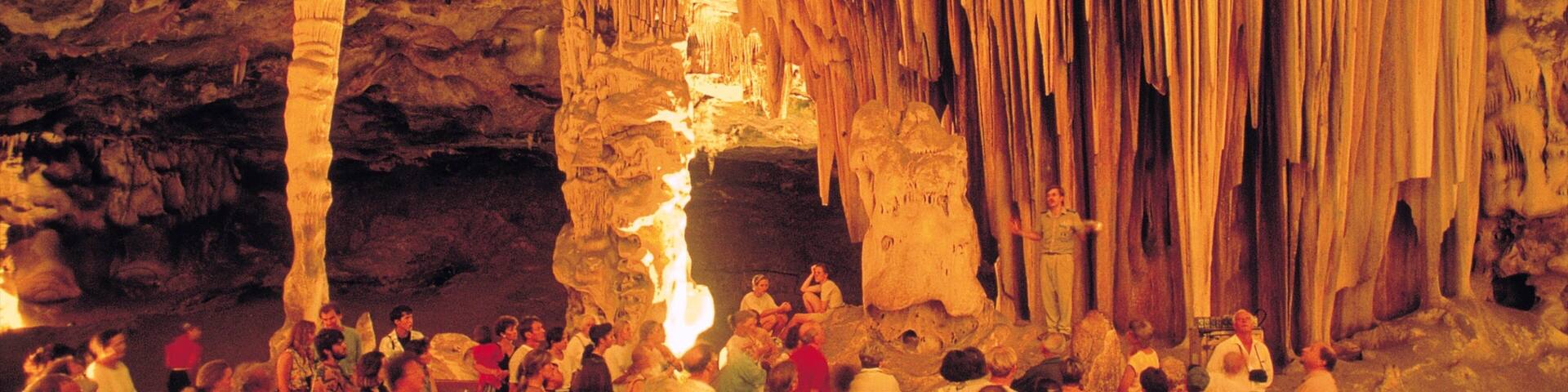 Oudtshoorn featuring interior views and caves as well as a large group of people