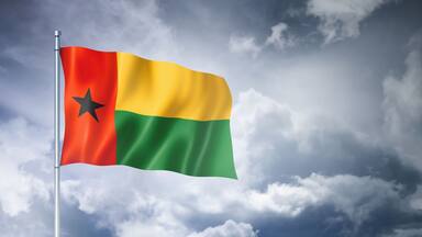 Guinea Bissau flag on a cloudy sky