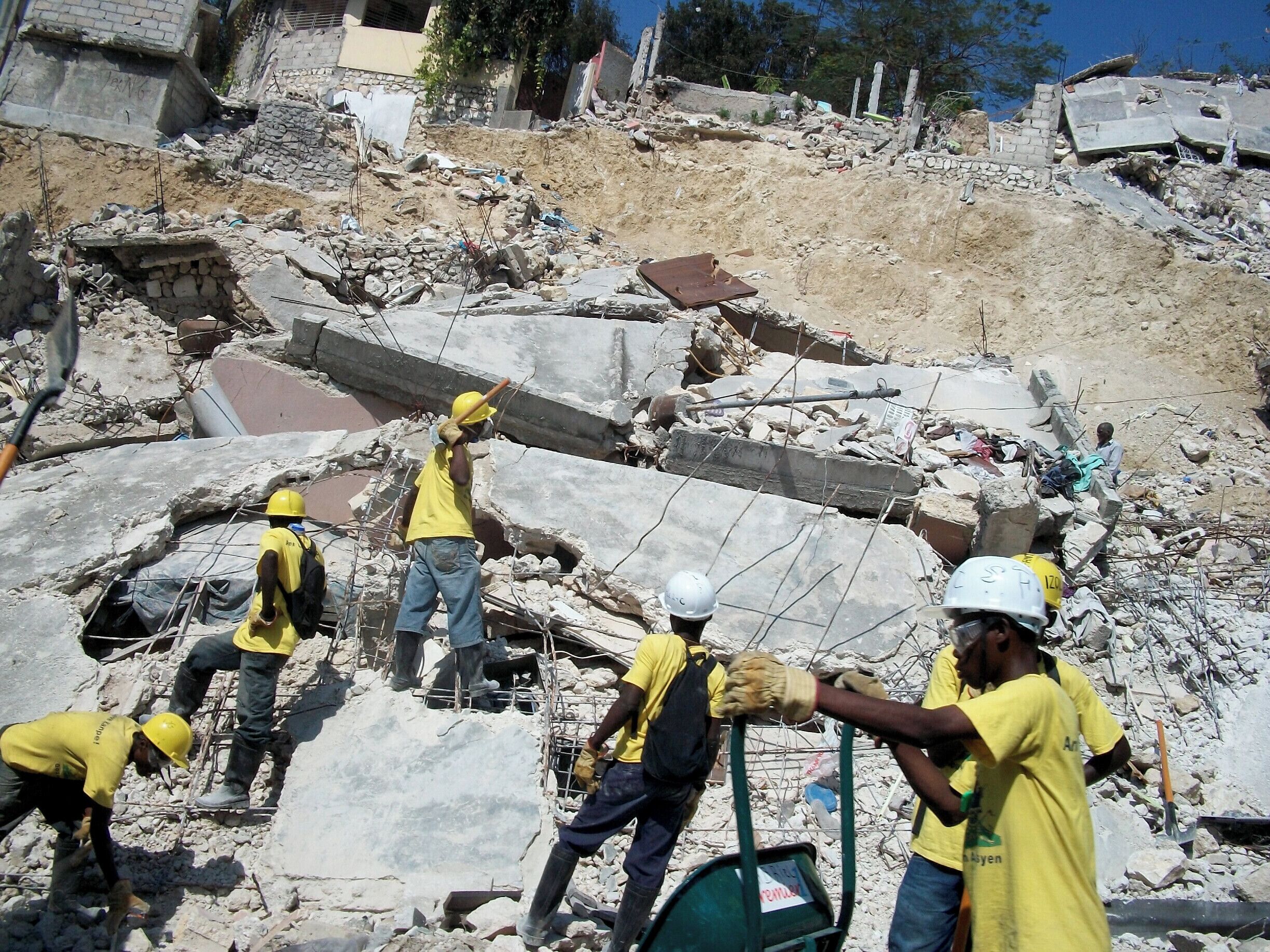 Hand tools and plastic buckets......Clearing the rubble in Port-au-Prince after the 2010 earthquake.  This team was paid for and supported by one of the many NGO's.  A conscious decision was made to remove the rubble this way to provide more jobs, and strive to keep the streets open.  Picture 3 of 3.