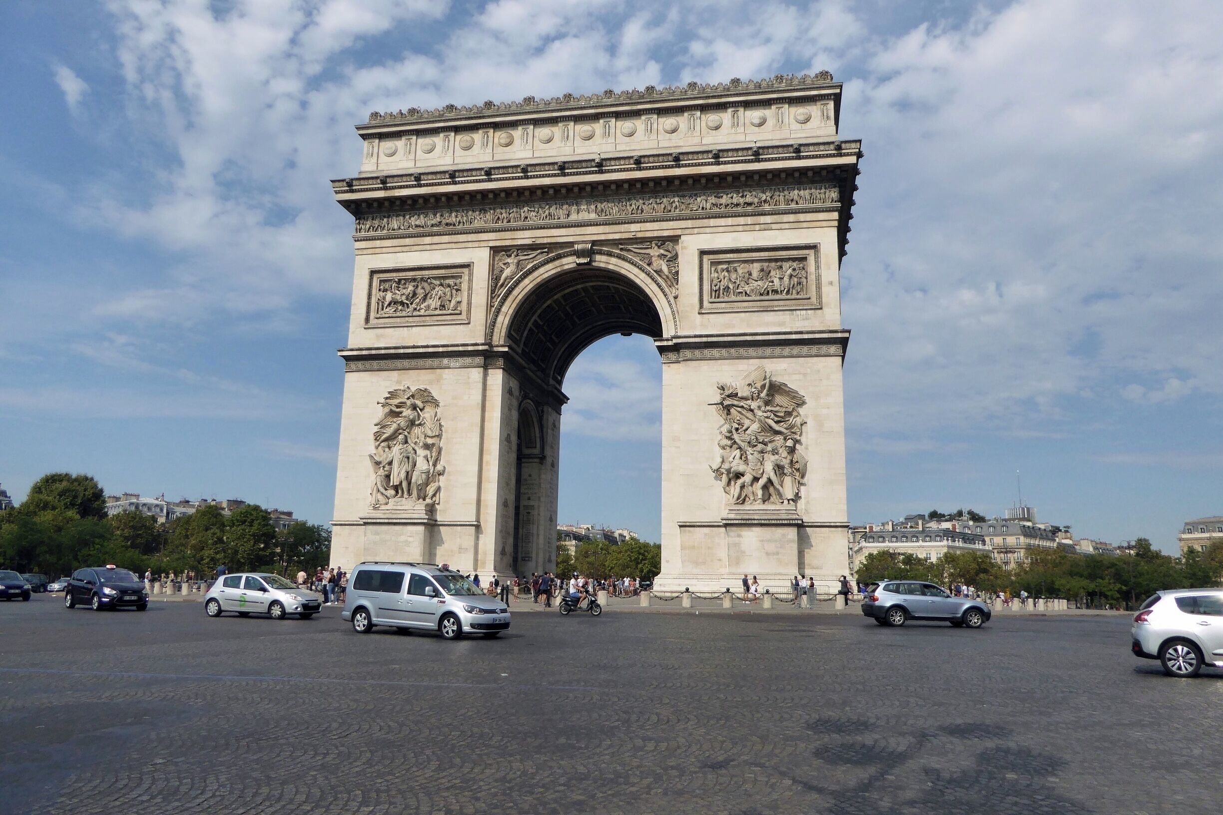 The Arc de Triomphe at the 12 road junction on Place Charles de Gaulle. Built as a monument to those who fought and died in the French Revolutionary & Napoleoninc Wars. The names of all the French victories & generals are inscribed on it's surfaces and the Tomb of The Unknown Soldier from World War 1 lies under it.