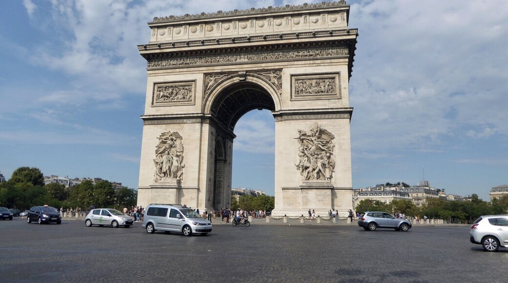 The Arc de Triomphe at the 12 road junction on Place Charles de Gaulle. Built as a monument to those who fought and died in the French Revolutionary & Napoleoninc Wars. The names of all the French victories & generals are inscribed on it's surfaces and the Tomb of The Unknown Soldier from World War 1 lies under it.