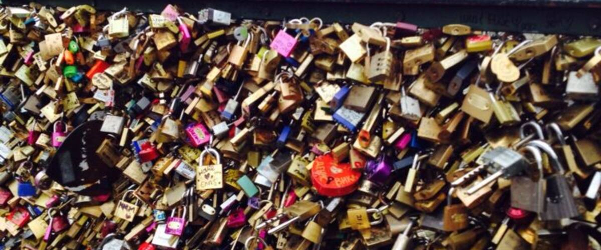 Pont des Artes Pedestrian bridge near the Louvre. Also known as Love Lock Bridge. People write their names on the locks, place it on the bridge and toss the keys into the Seine to show Devotional Love.