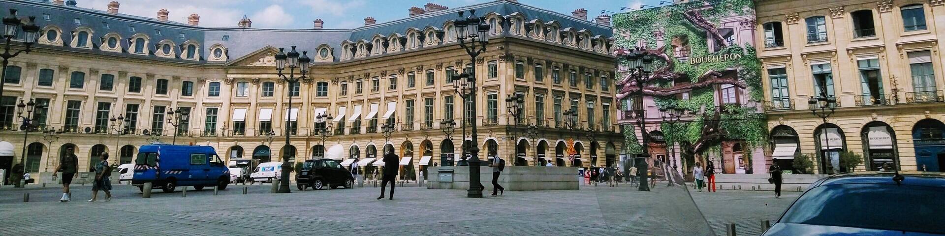 A historic building with ornate architecture and a cobblestone plaza.
