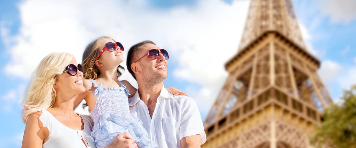 A family with a child in front of the Eiffel Tower.