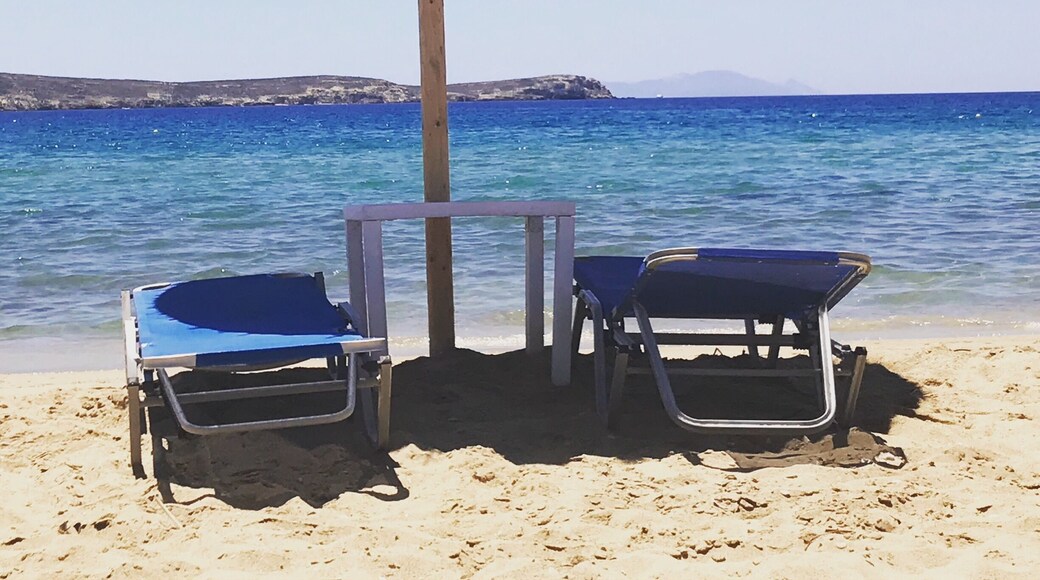 Golden Beach on the island of Paros, Greece. Big, long stretch of Beach with soft golden sand. There are big rocks in the ocean so be careful when you walk in. Water is clear so you can see down to the ocean floor. #paros #greece #beach #goldenbeach