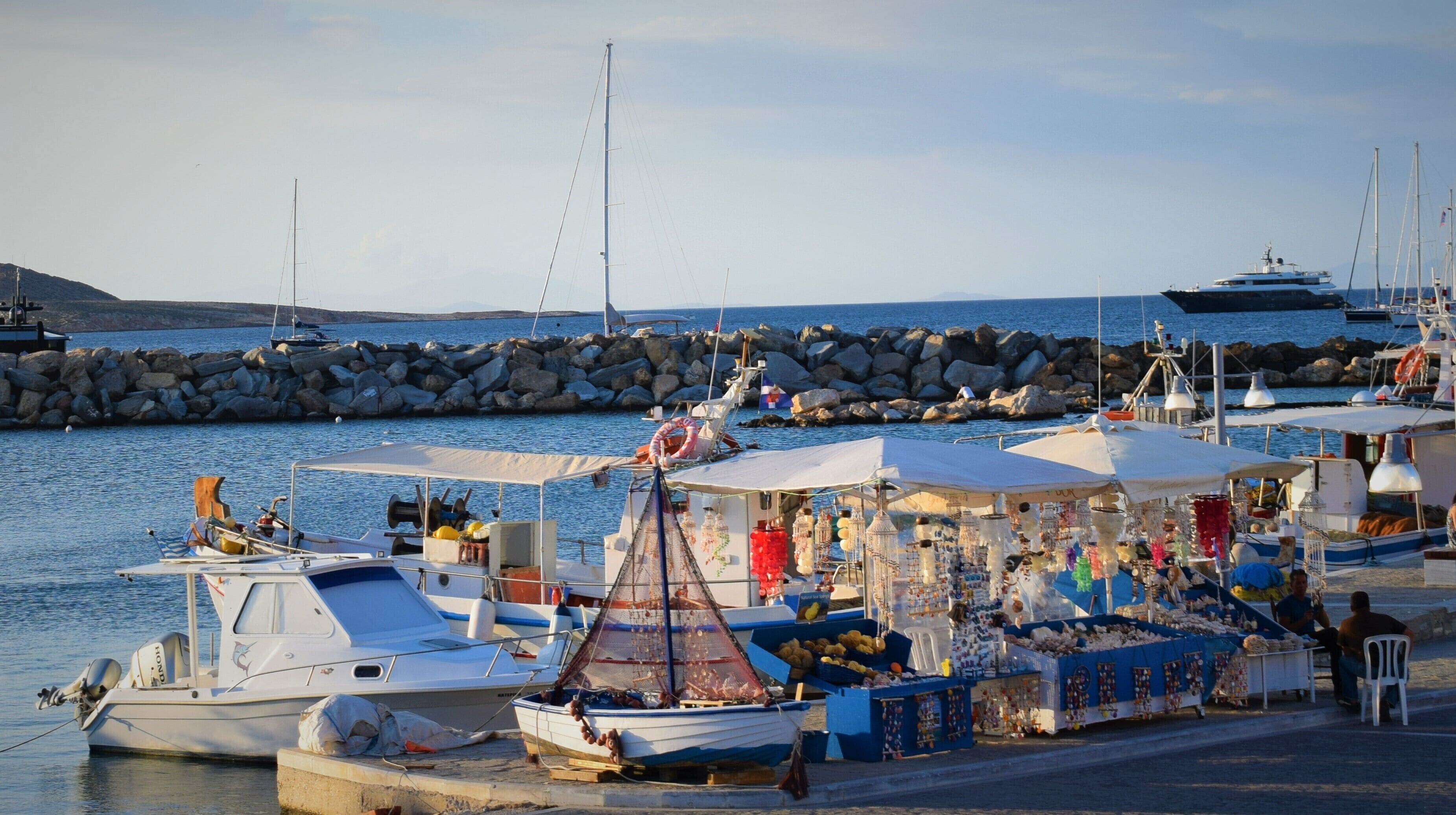 Colorful boats which you can buy shells and sponges with great lighting! It smells summer and we like it here in Greece cause it is our "Retail Therapy"! 
#RetailTherapy #LifeAtExpedia