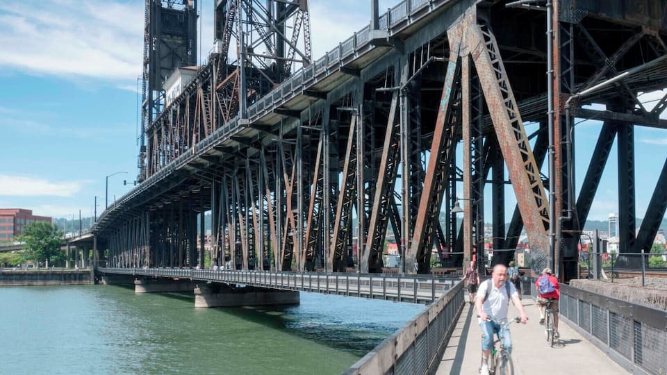 Cross back across the Willamette River along the pedestrian walk below the Steel Bridge to the East side Esplanade.