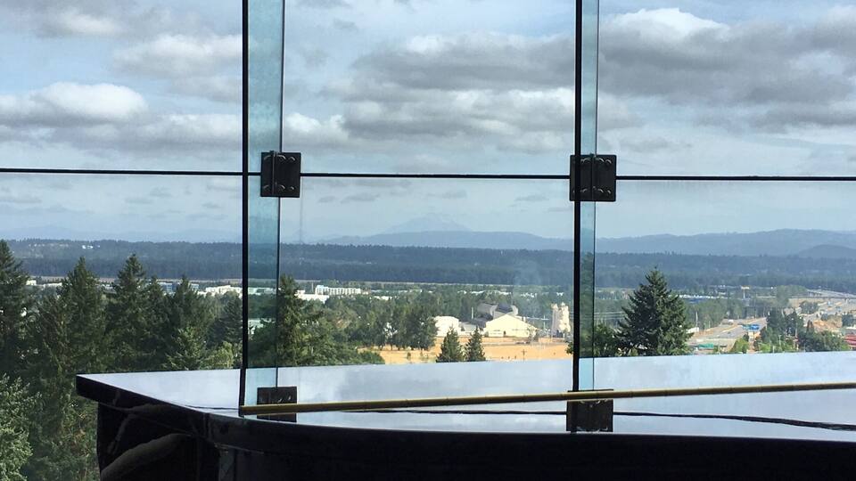A view through a window with a clear sky and distant landscape.
