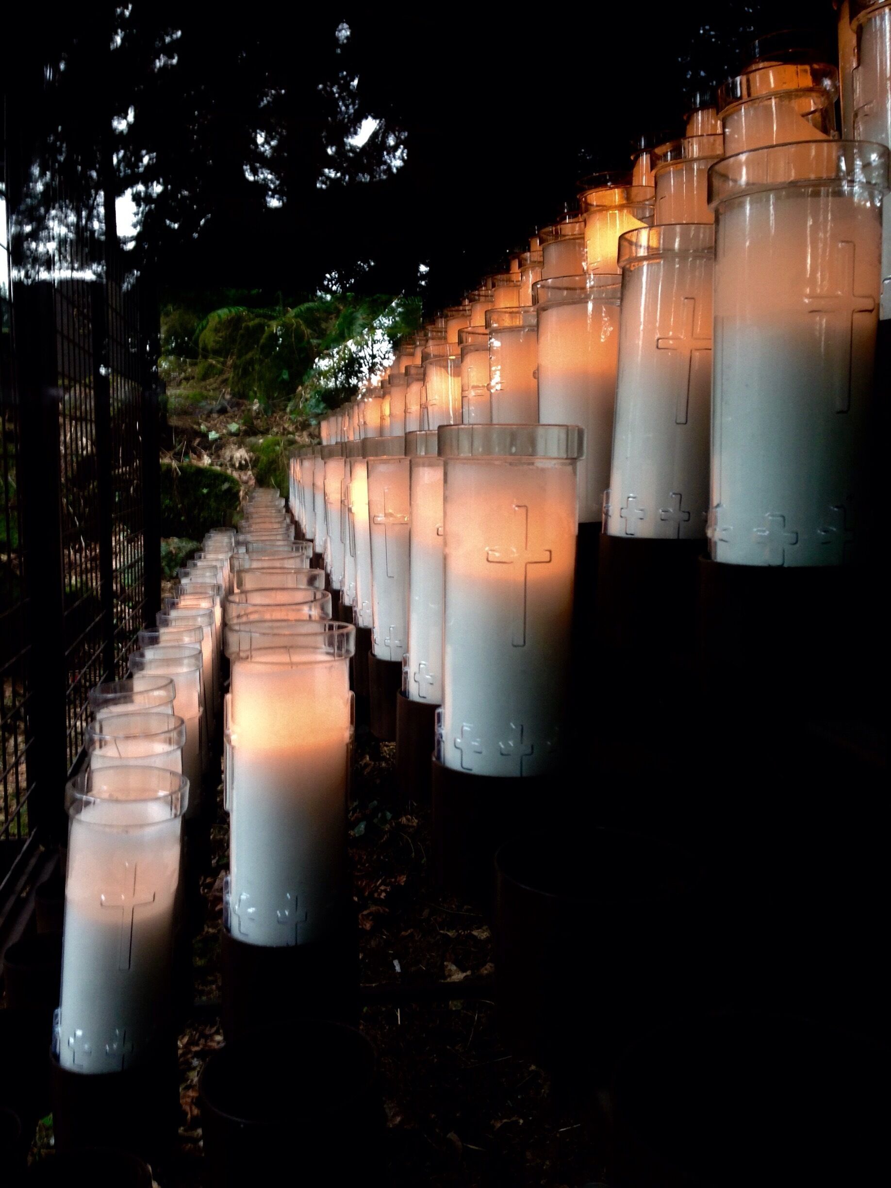 Votive candles flank each side of the grotto  in Portland. 