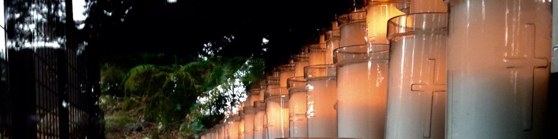 Votive candles flank each side of the grotto in Portland.