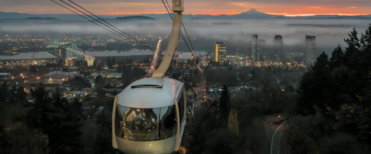 Sunrise from the upper tram terminal at Oregon Health Science University. Timing is everything in photography. I have waited a year to get the right timing and weather for this shot. For those fortunate enough to ride the tram daily this is a common sight. Mount Hood in the background.