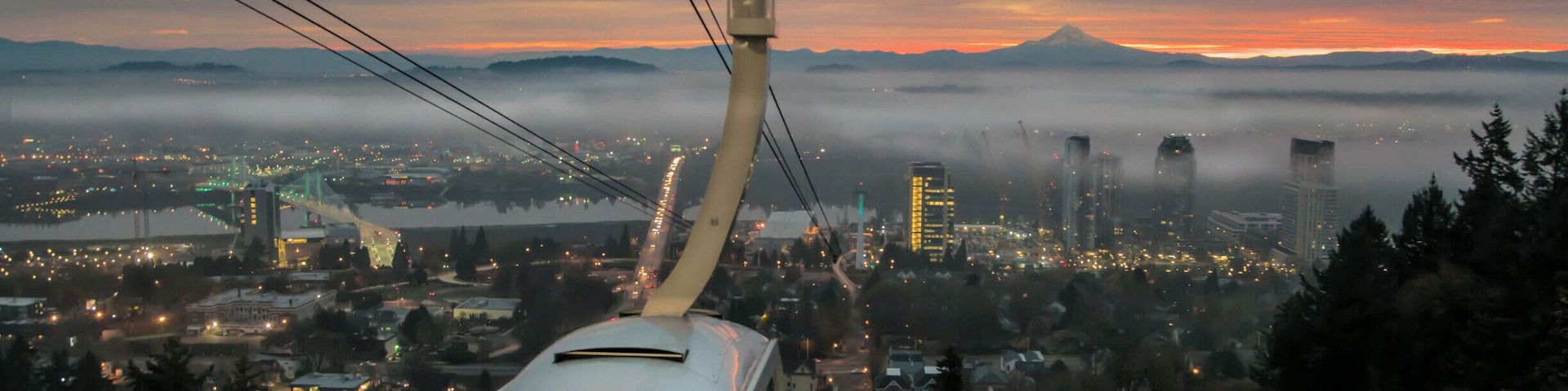 Sunrise from the upper tram terminal at Oregon Health Science University. Timing is everything in photography. I have waited a year to get the right timing and weather for this shot. For those fortunate enough to ride the tram daily this is a common sight. Mount Hood in the background.