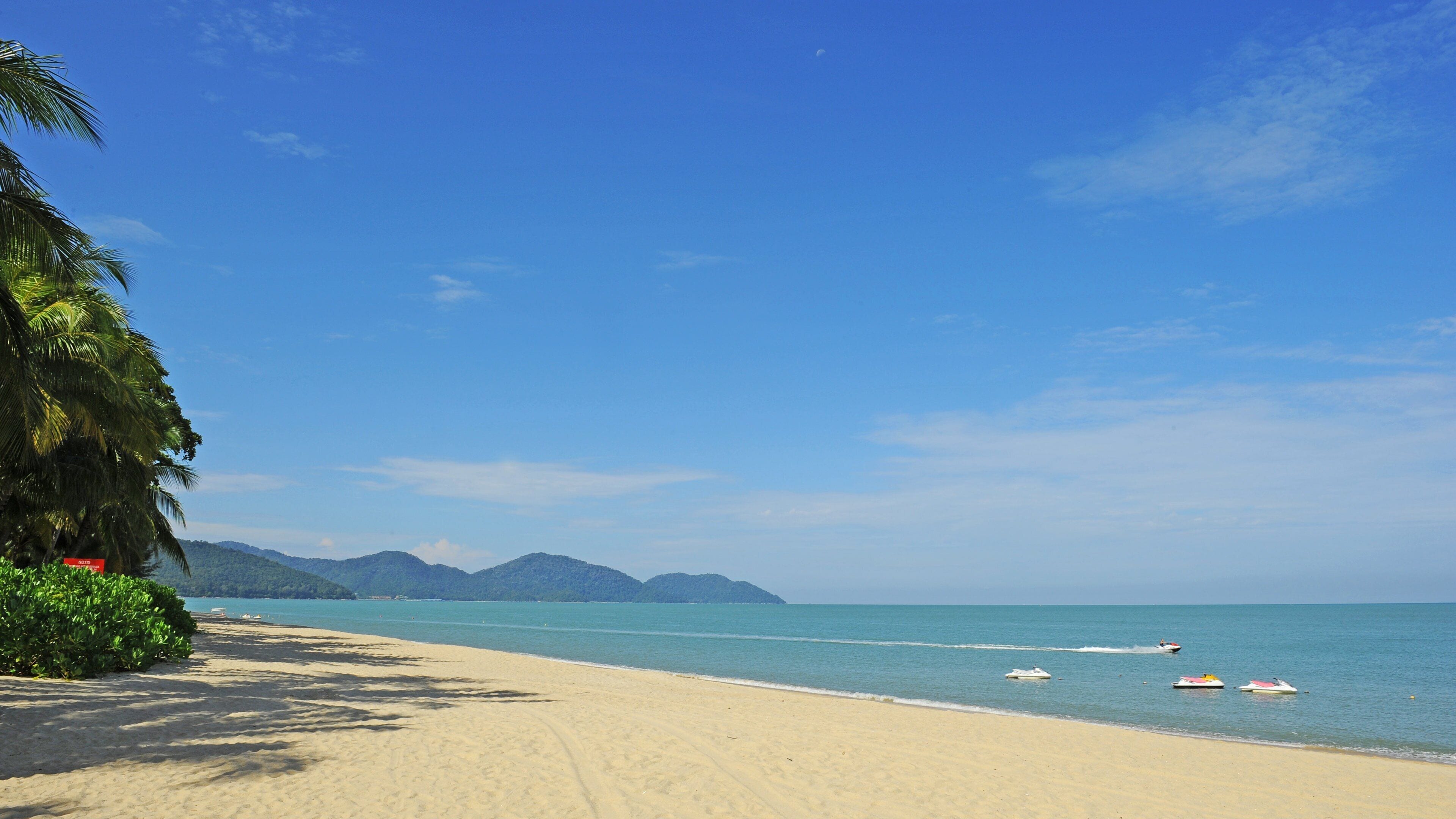 Penang featuring general coastal views, jet skiing and a beach