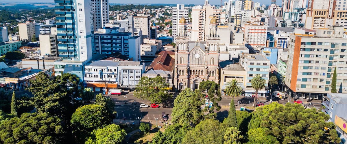 A cityscape with a mix of modern and historic buildings, including a prominent church with a dome.