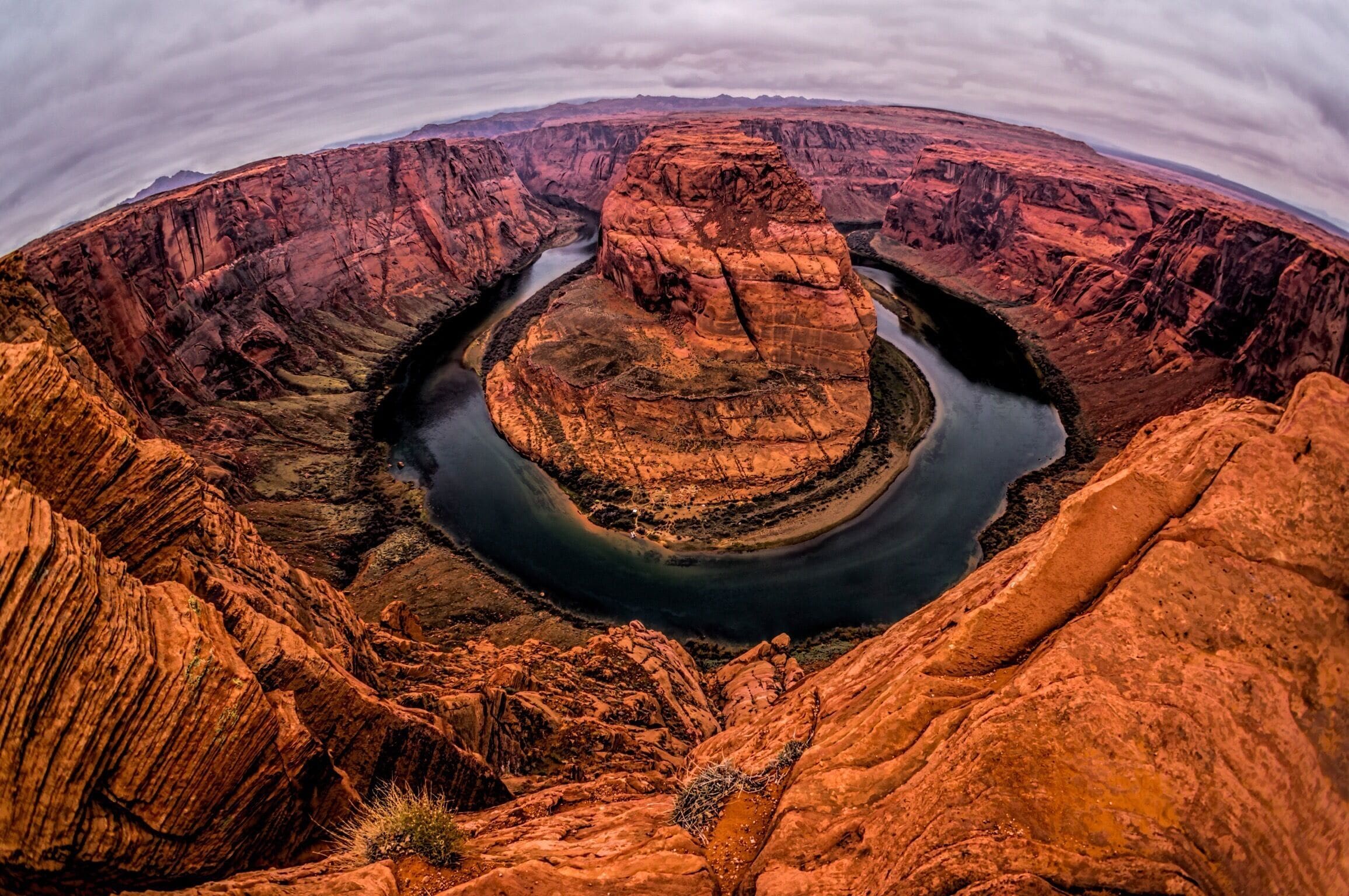 A deep canyon with a river winding through it.