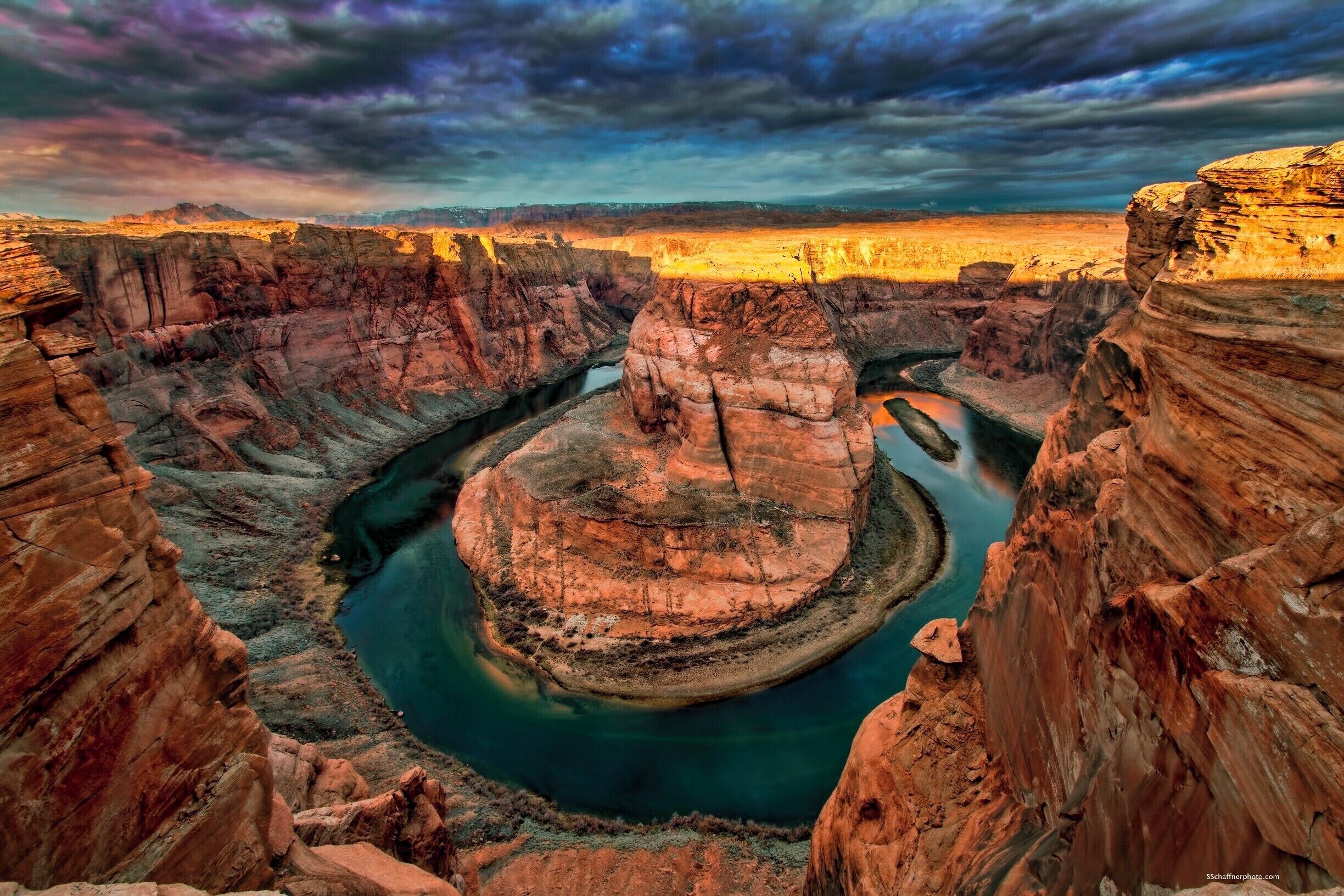Got this great shot but almost went over the side. Big chunk of sandstone I was sitting on broke loose and slid only to stop about 1 foot or so from the edge.
Camera on end of tripod and release in hand. I saved all my gear as my life flashed before me. 
Don't get to close to the edge. That sandstone is old and can give way at any time without notice!