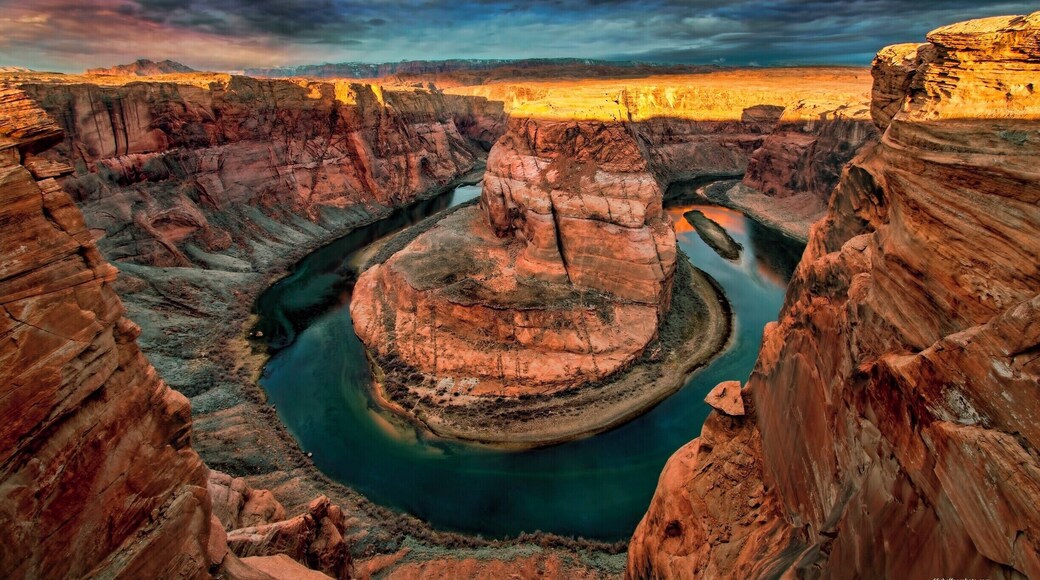 Got this great shot but almost went over the side. Big chunk of sandstone I was sitting on broke loose and slid only to stop about 1 foot or so from the edge.
Camera on end of tripod and release in hand. I saved all my gear as my life flashed before me.
Don't get to close to the edge. That sandstone is old and can give way at any time without notice!