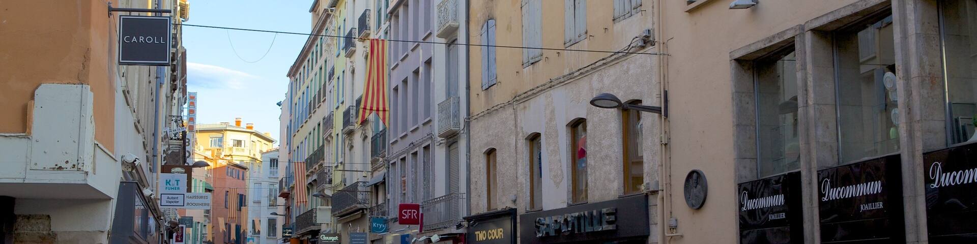 A street lined with shops and buildings, including a sign for 'CAROLL'.