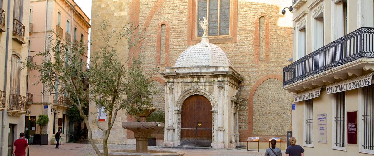 A plaza with a fountain, a church with a dome, and a building with a sign.