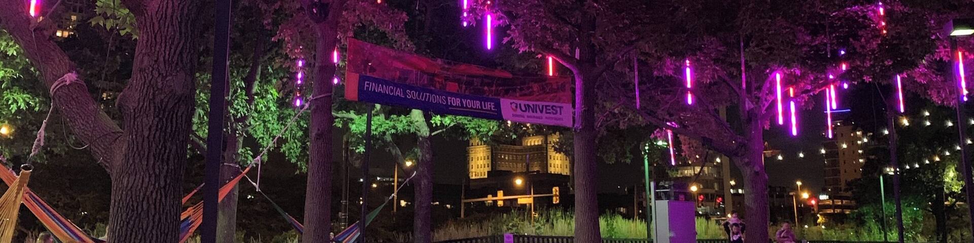 A tree with hanging lights and a sign that reads "Financial Solutions for Your Life."