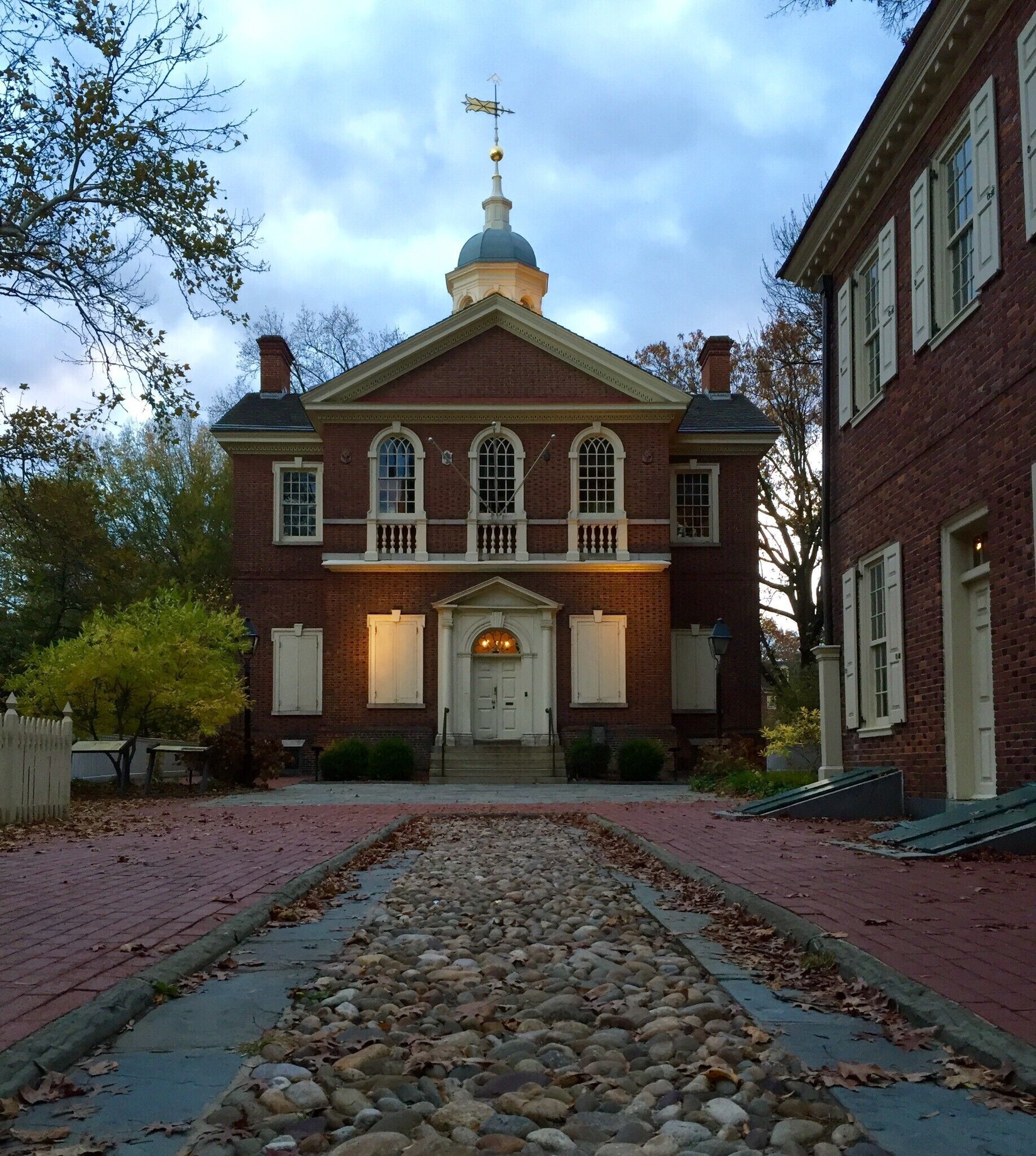 A historic building with a central dome and a brick facade.