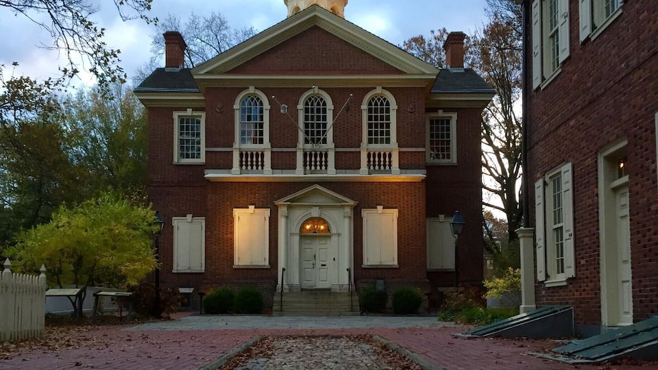 A historic building with a central dome and a brick facade.