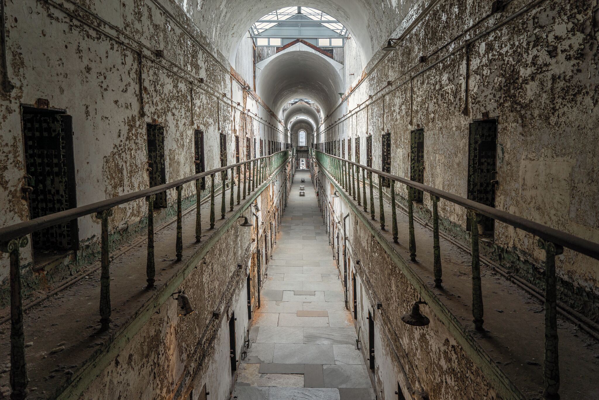 Built in 1829, Eastern State Penitentiary is considered to be the world's first true penitentiary. Upon completion, it was the largest and most expensive public structure ever erected in the United States. 
Several notorious criminals were held at Eastern State, including Al Capone and bank robber Willie Sutton.
The prison operated until 1971, after which it was closed and abandoned.
