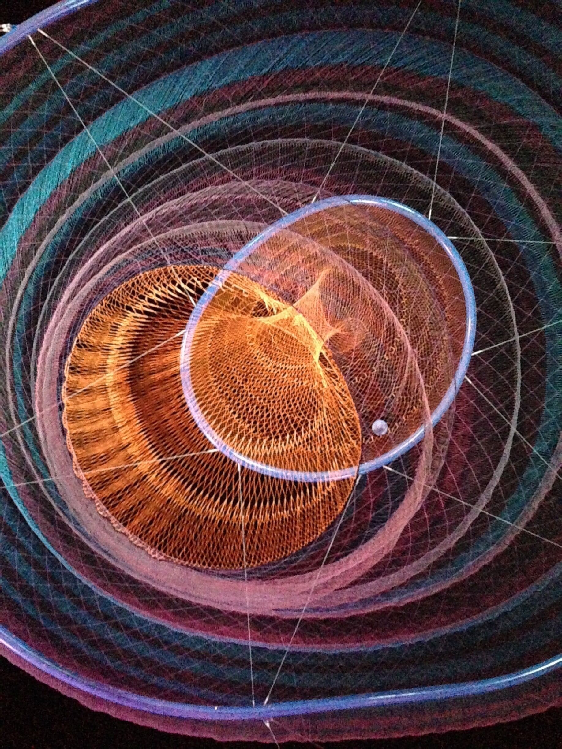 Underneath a sculpture by Janet Echelman. Saw this in the day then decided to go at night and it had a completely different personality