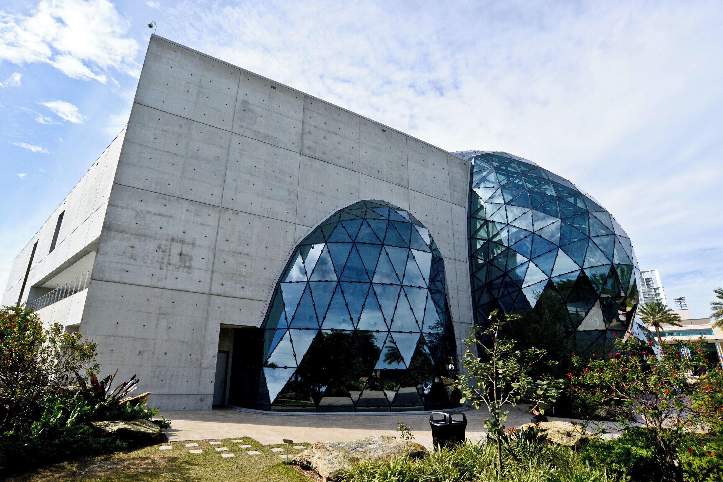 A modern building with large glass windows and a concrete facade.