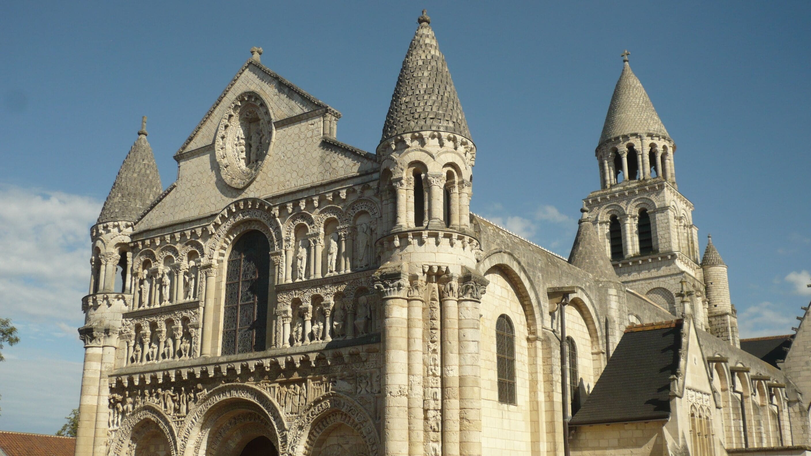 A Gothic cathedral with pointed arches, intricate stone carvings, and multiple spires.