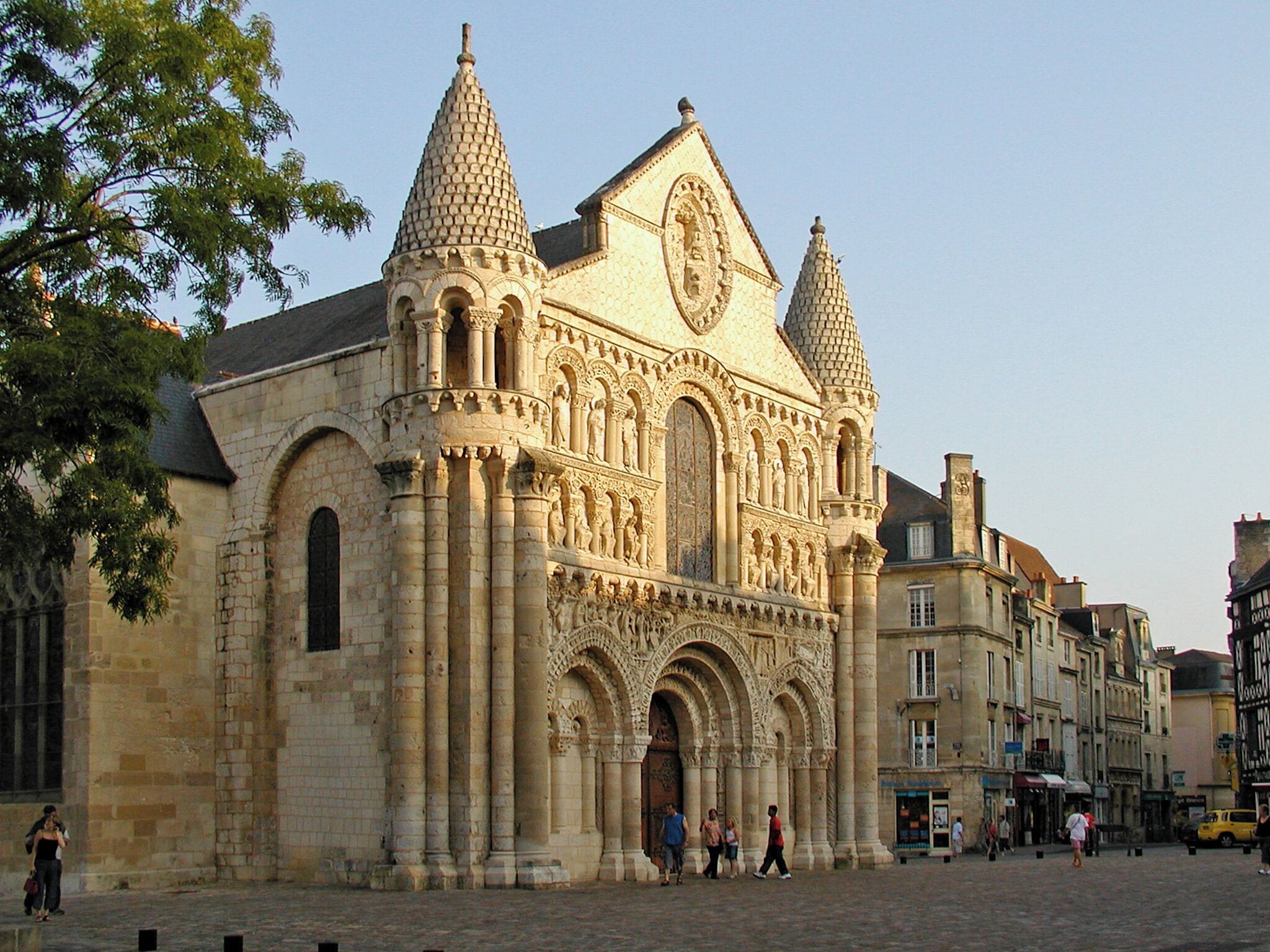 A historic cathedral with intricate stone carvings and two prominent spires.