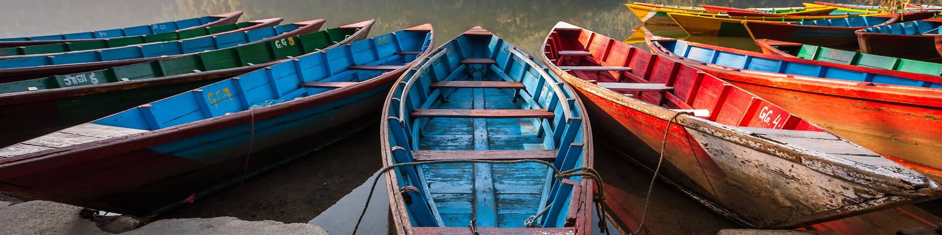 Colorful boats in Phewa lake in Pokhara, Nepal